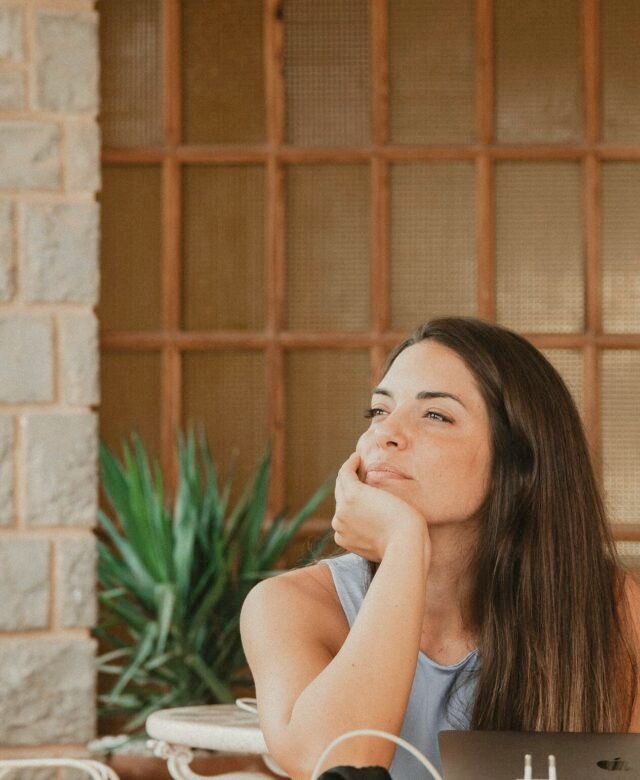 Retrato de una emprendedora trabajando con su portátil junto a una ventana